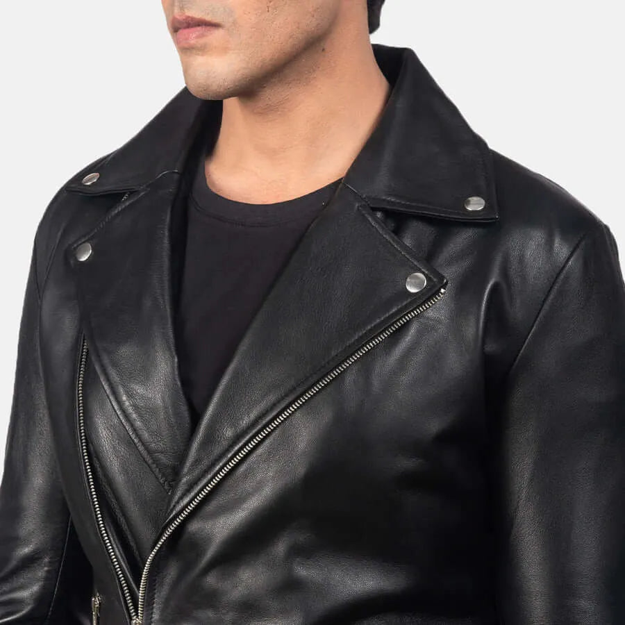 Close-up of a person wearing a black leather jacket with a plain background