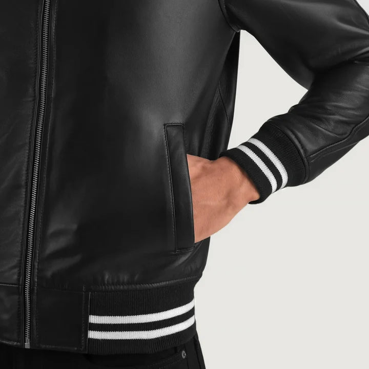 Black leather jacket with white stripes on cuffs and hem against a light gray background