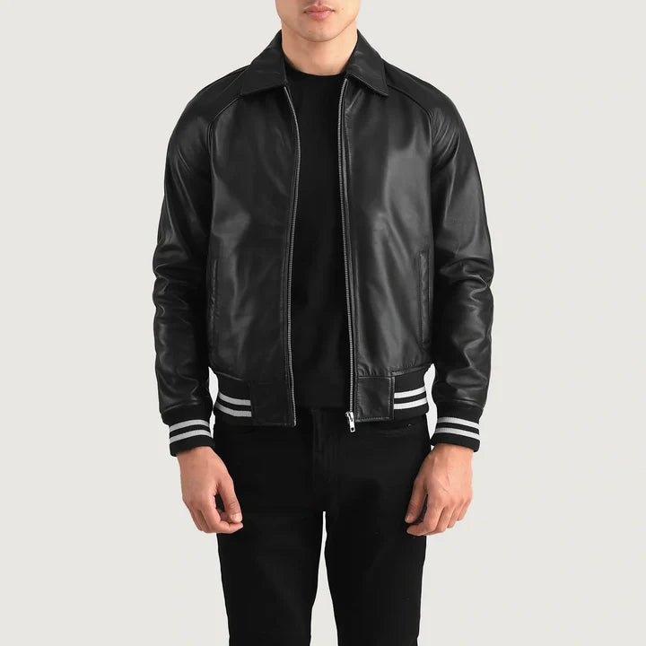 Person wearing a black leather jacket with white stripes on a light gray background