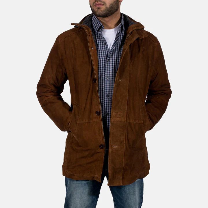 Man wearing a brown hooded jacket over a checkered shirt on a white background