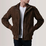 Brown suede jacket worn by a person on a plain background