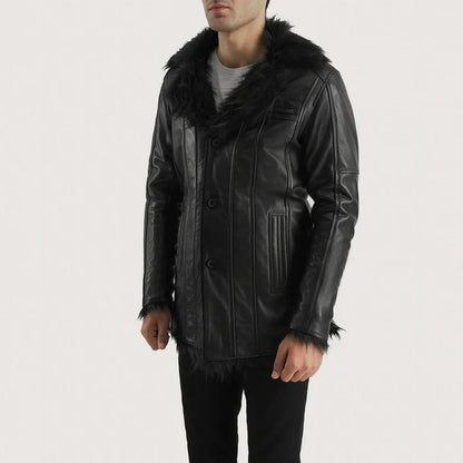 Man wearing a black leather jacket with fur trim on a white background