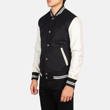 Black and white varsity jacket worn by a person on a white background