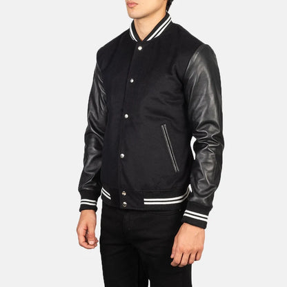 Black varsity jacket with leather sleeves on a white background