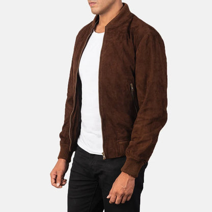 Man wearing a brown suede jacket over a white shirt on a white background