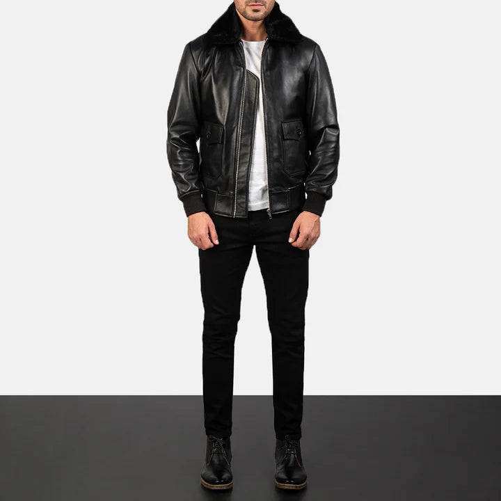 Person wearing a black leather jacket and pants on a white background