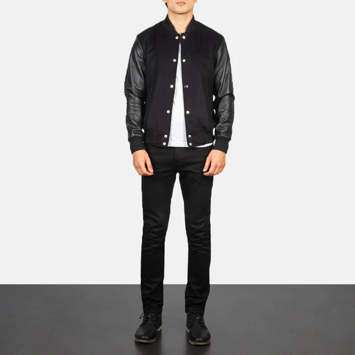Person wearing a black leather jacket and pants on a plain background
