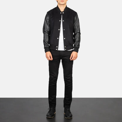 Person wearing a black leather jacket and pants on a plain background