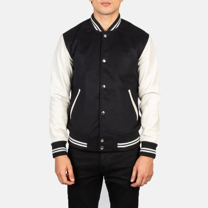 Black and white varsity jacket worn by a person on a white background