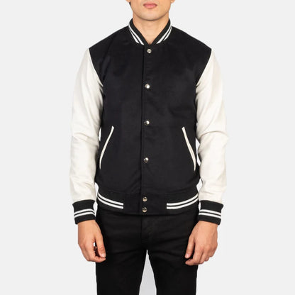 Black and white varsity jacket worn by a person on a white background