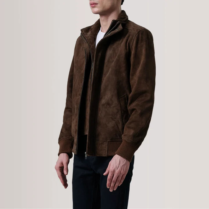 Man wearing a brown jacket on a plain background