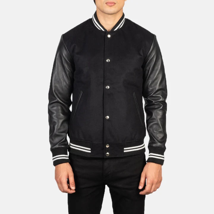 Black varsity jacket with leather sleeves on a white background