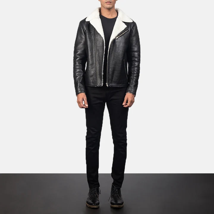 Person wearing a black leather jacket with white fur lining on a plain background