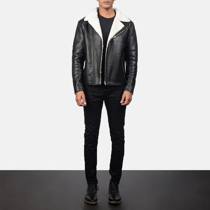 Person wearing a black leather jacket with white fur lining on a plain background