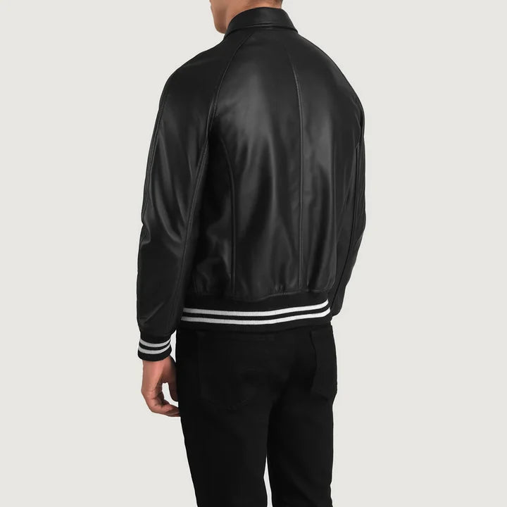 Person wearing a black bomber jacket with white stripes on a light gray background