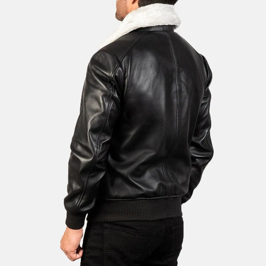 Black leather bomber jacket with white fur lining on a plain background