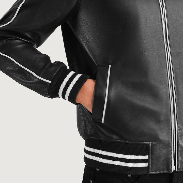 Black leather jacket with white stripes on sleeves and hem against a light gray background
