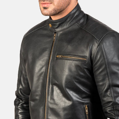 Black leather jacket with gold zipper details on a plain background
