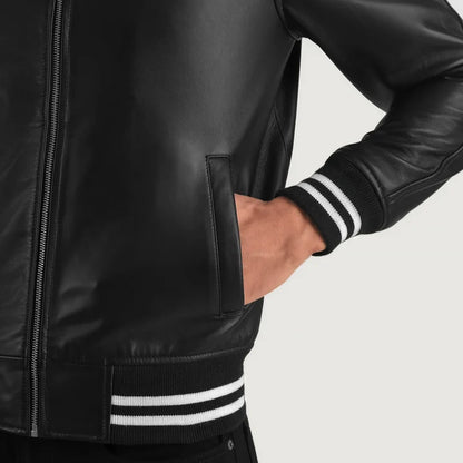 Black leather jacket with white stripes on cuffs and hem against a light gray background