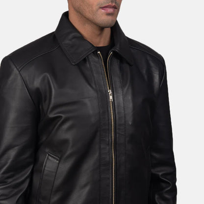 Black leather jacket with a zipper on a gray background