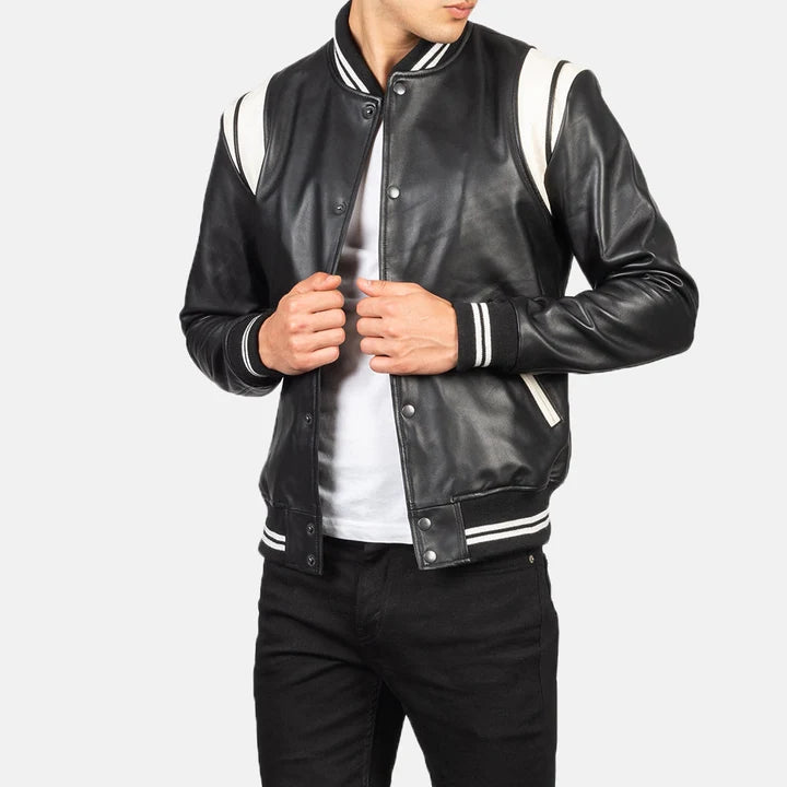 Person wearing a black leather jacket with white accents on a light gray background