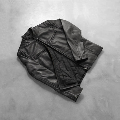 Black leather jacket on a gray concrete surface