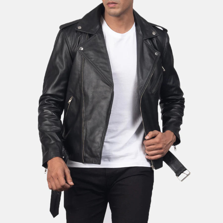 Person wearing a black leather jacket over a white shirt on a light gray background